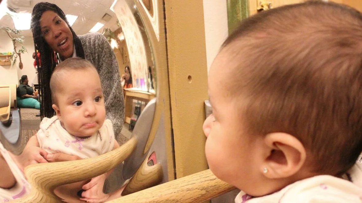 Caregiver and two babies exploring the Pritzker Playspace exhibit