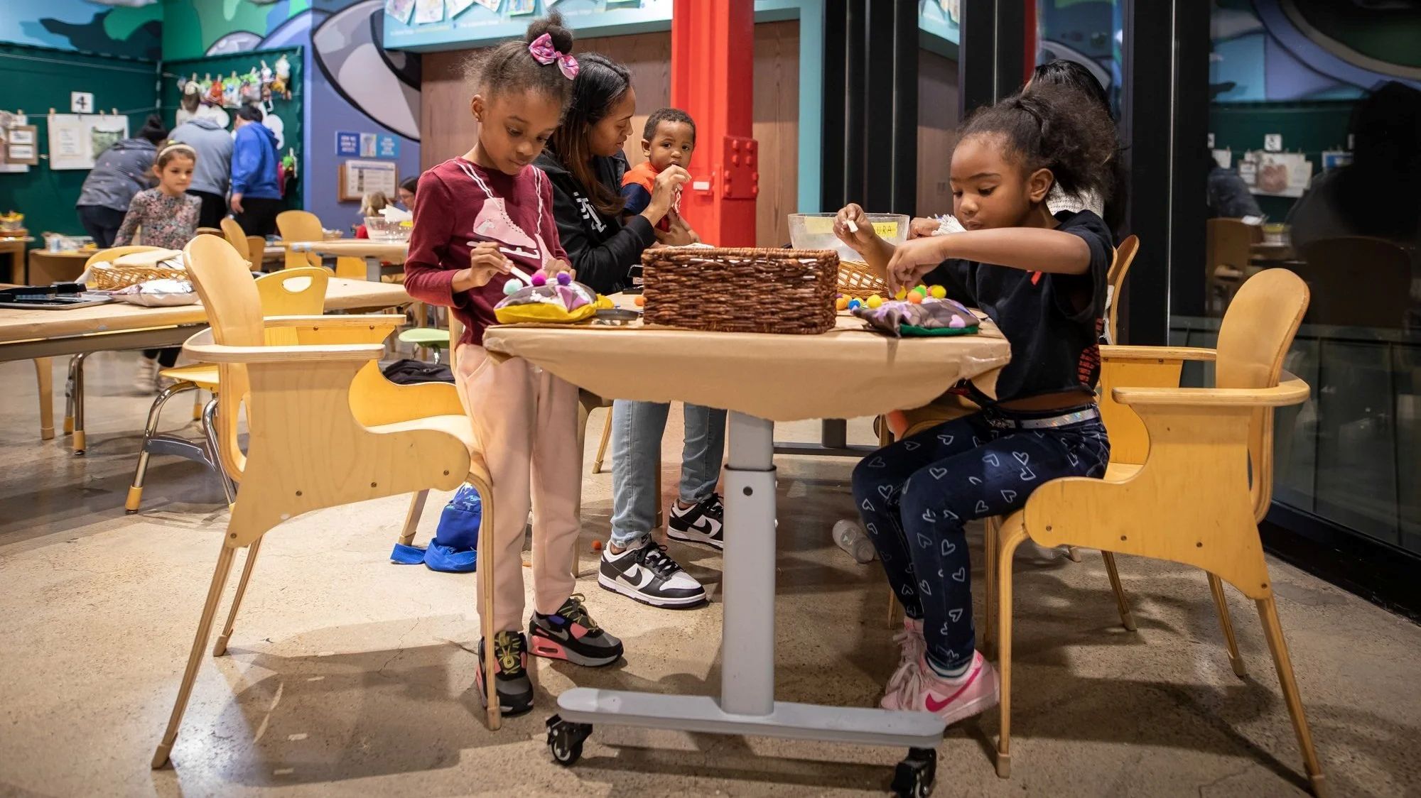 Children making crafts at a table in the museum art studio