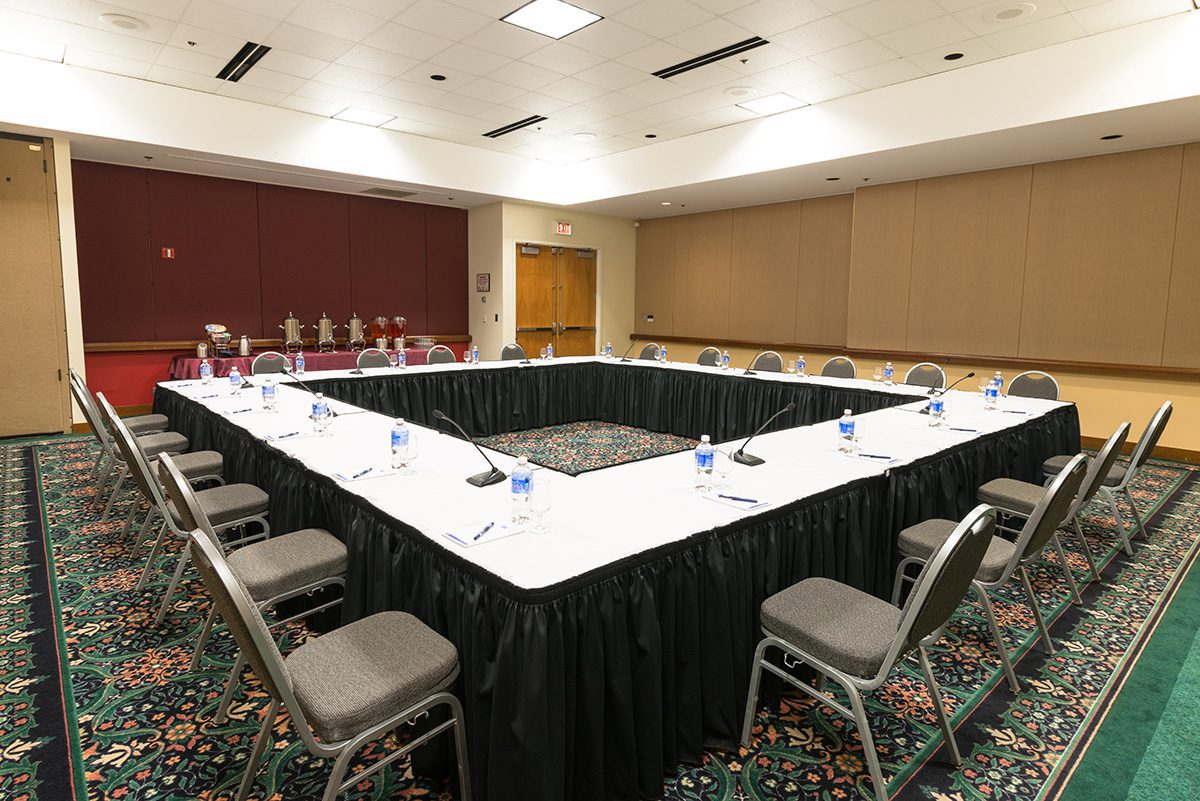 A Meeting Room Table Set Up In A Square