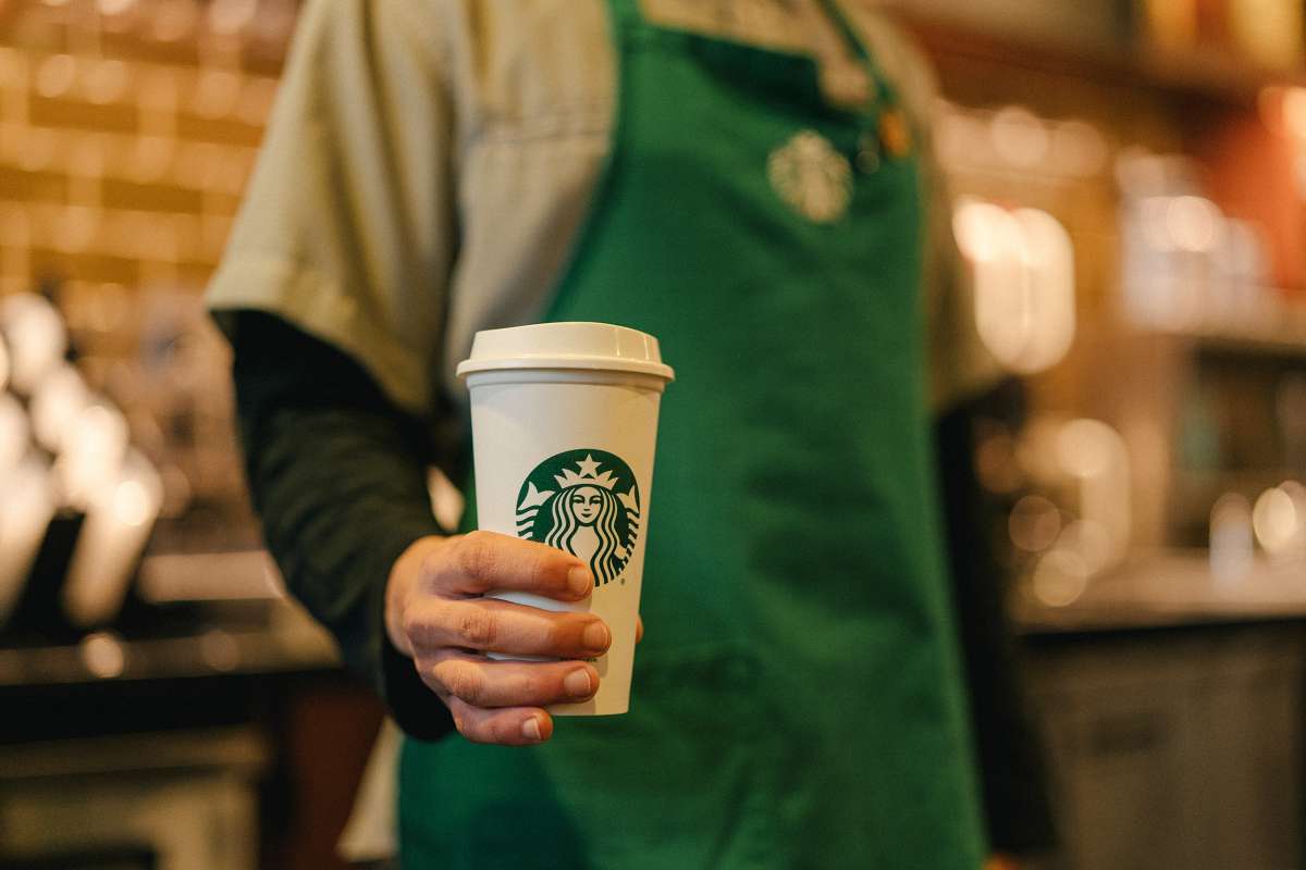 Starbucks - Barista holding coffee