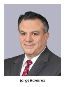 Jorge Ramirez, man in gray business suit with red tie