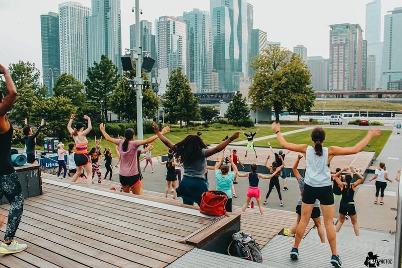 Rush Hour Fitness Class at Navy Pier with Chicago Skyline in the Background