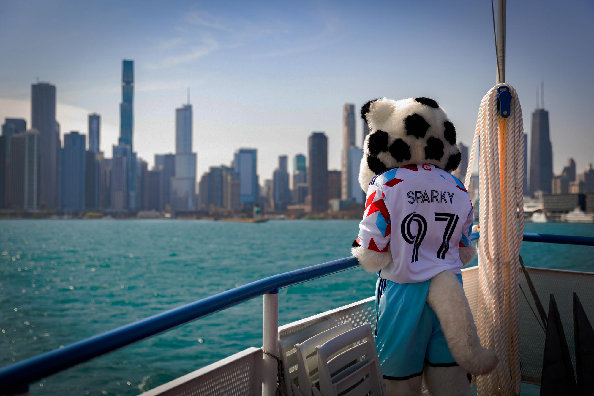 Sparky from Chicago Fire FC Looking with a View of the Chicago Skyline and Navy Pier