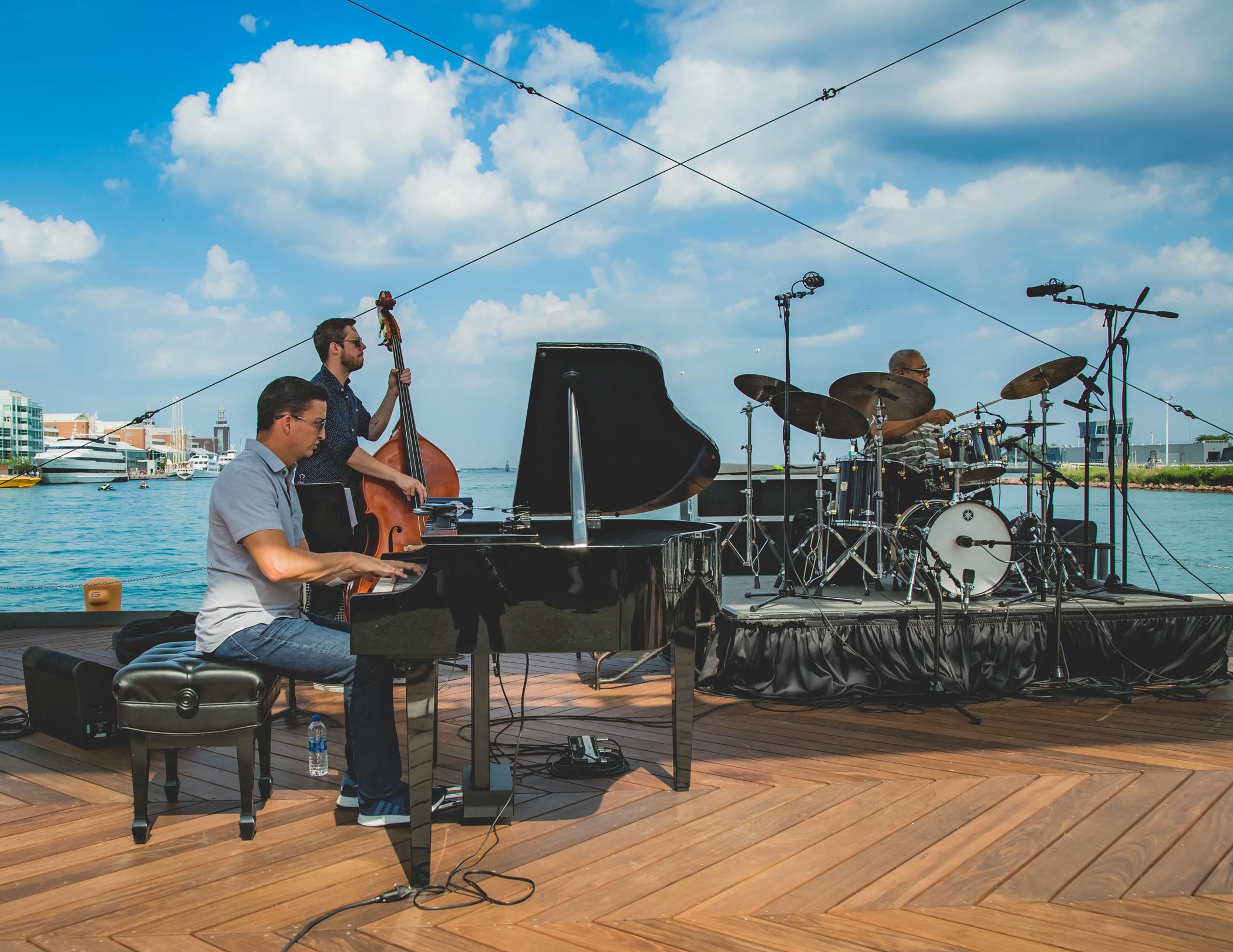 Piano, Bass, and Drum Performers at Water Colors with Lake Michigan and Navy Pier in the Background