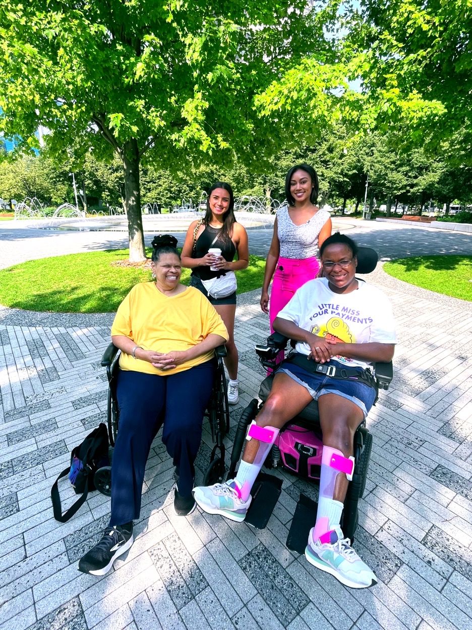 Four Women Smiling, Two in Wheelchairs