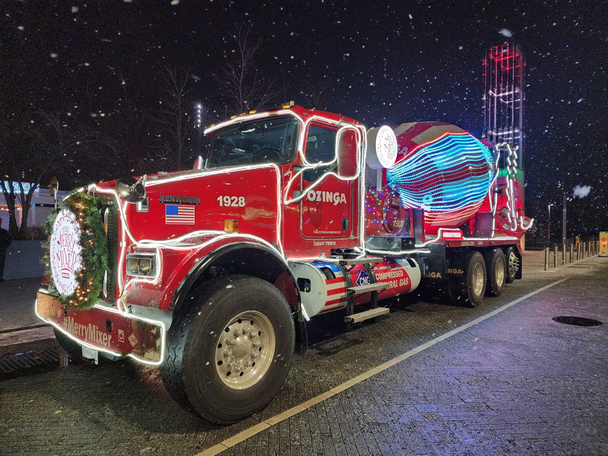 red ozinga holiday truck with white holiday lights