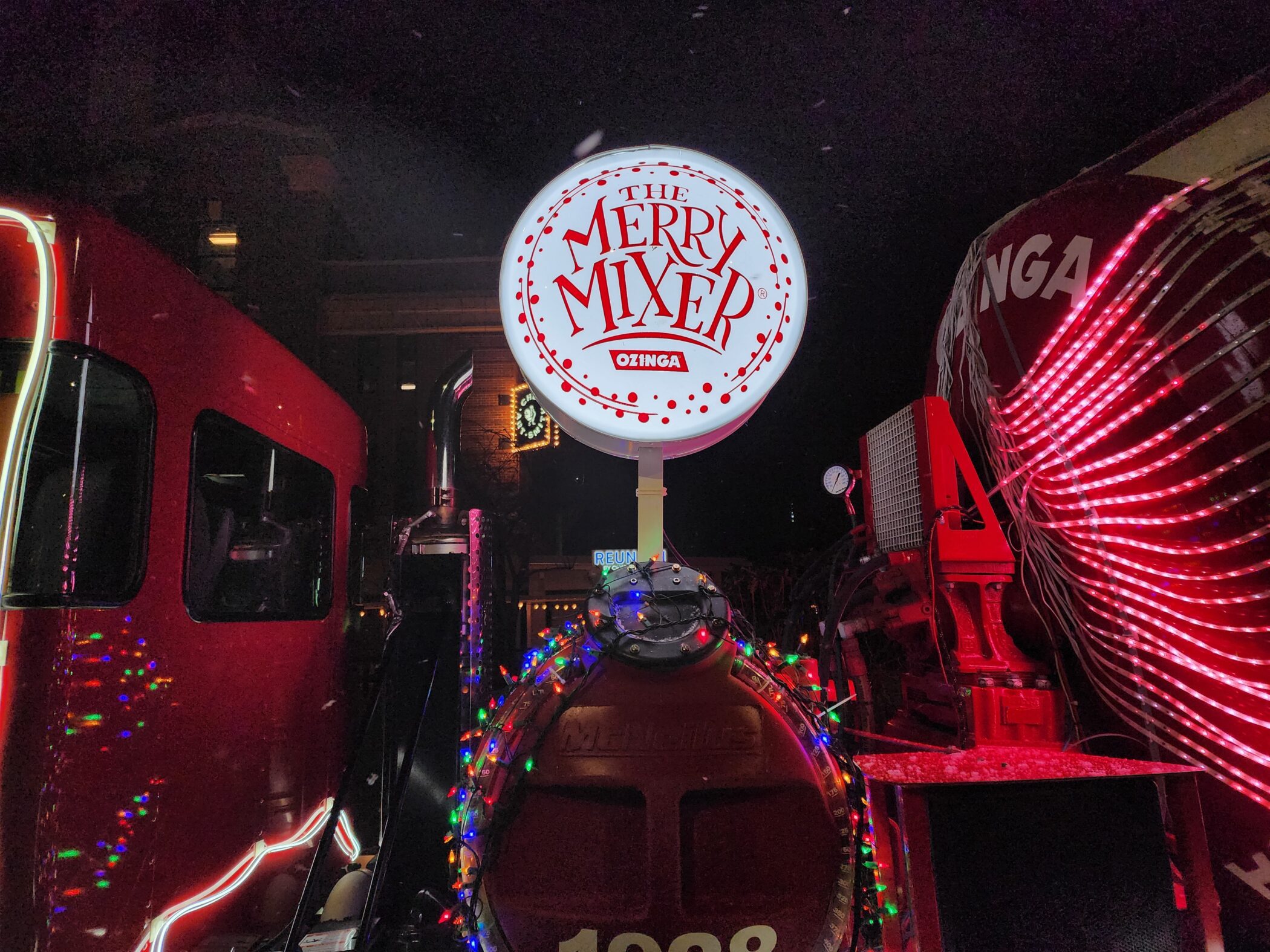 red ozinga holiday truck with white merry mixer sign