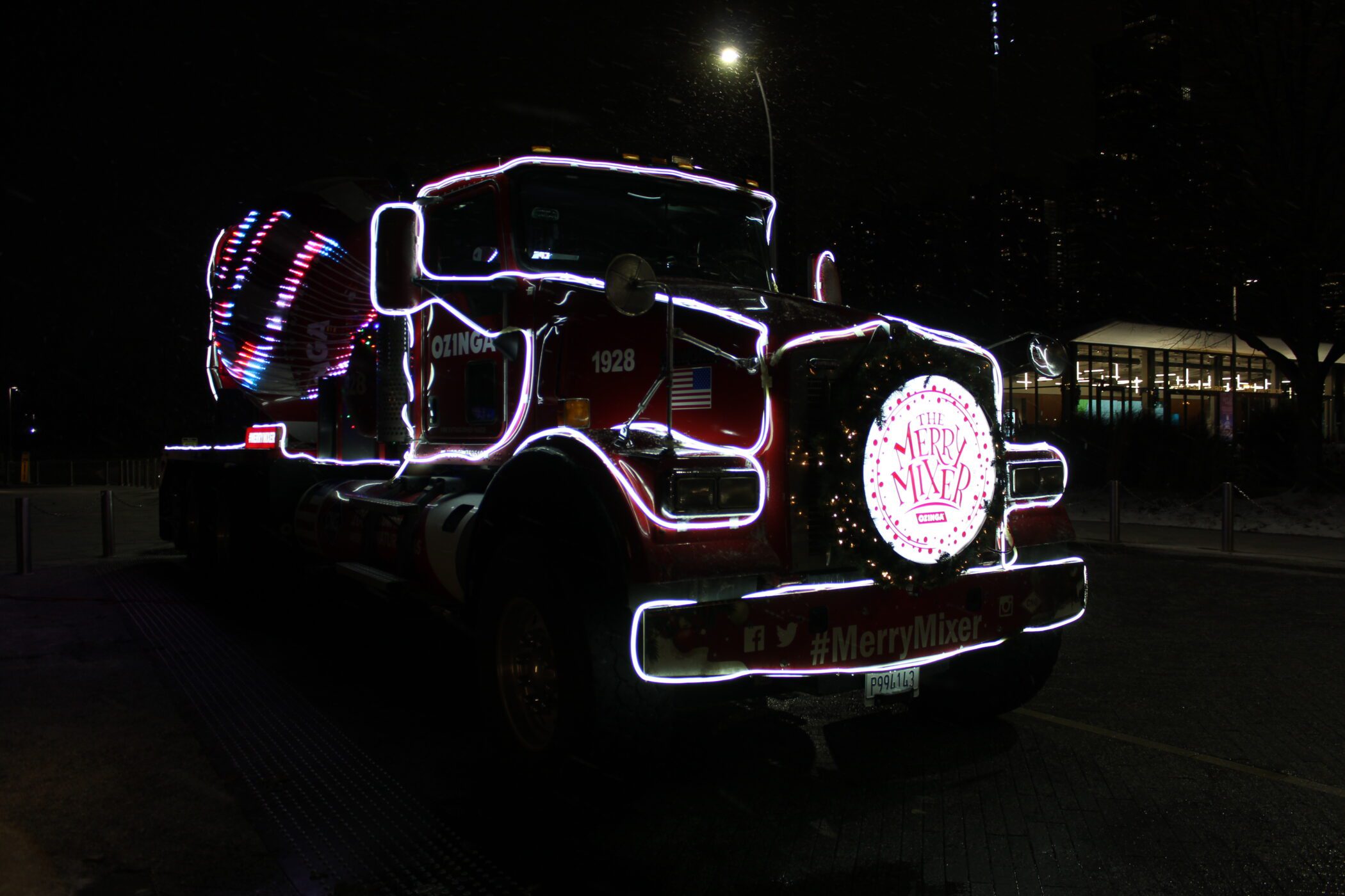 red ozinga holiday truck with white holiday lights