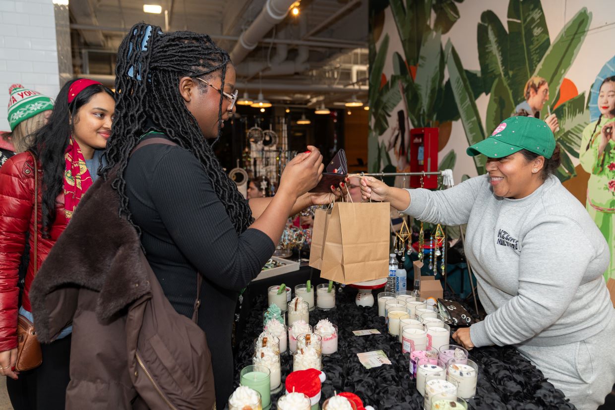 A vendor and customer at Lolita's Bodega Artisan Market.