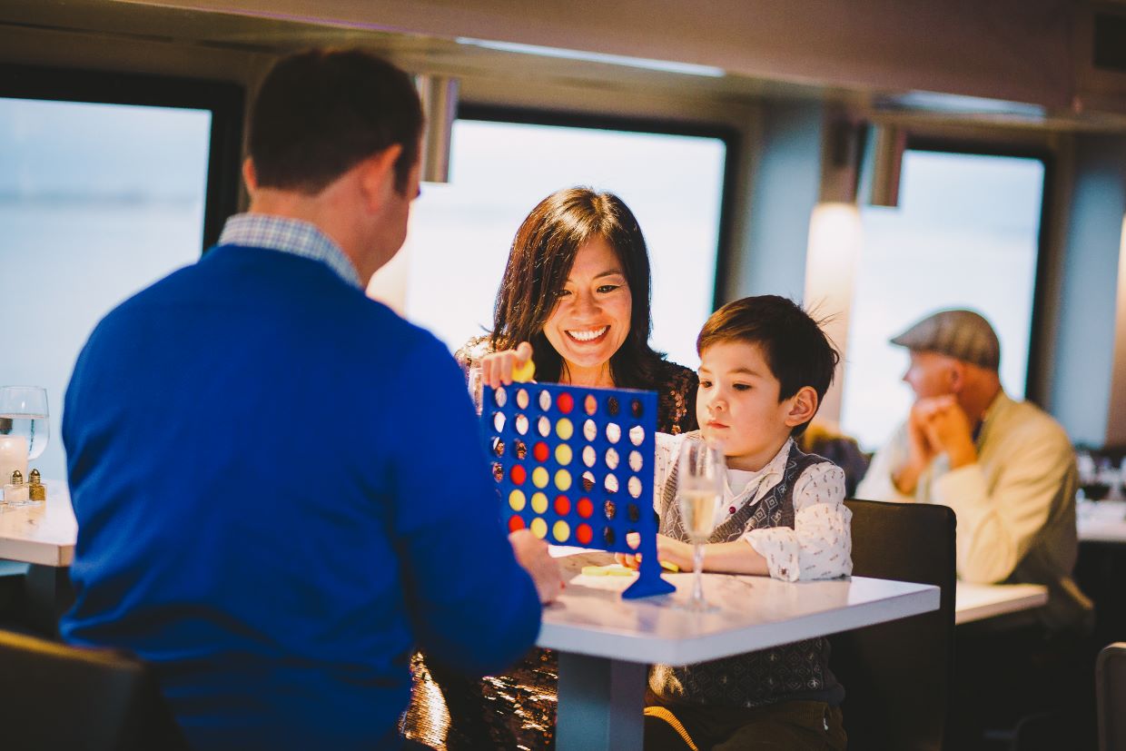 Family playing games aboard Valentine's Premier Dinner Cruise.