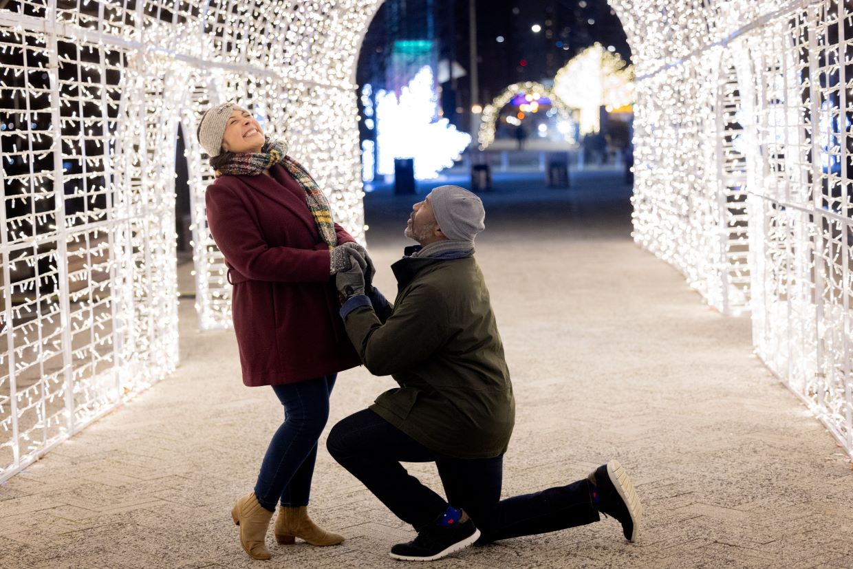 Proposal under light tunnel at Love at the Pier.