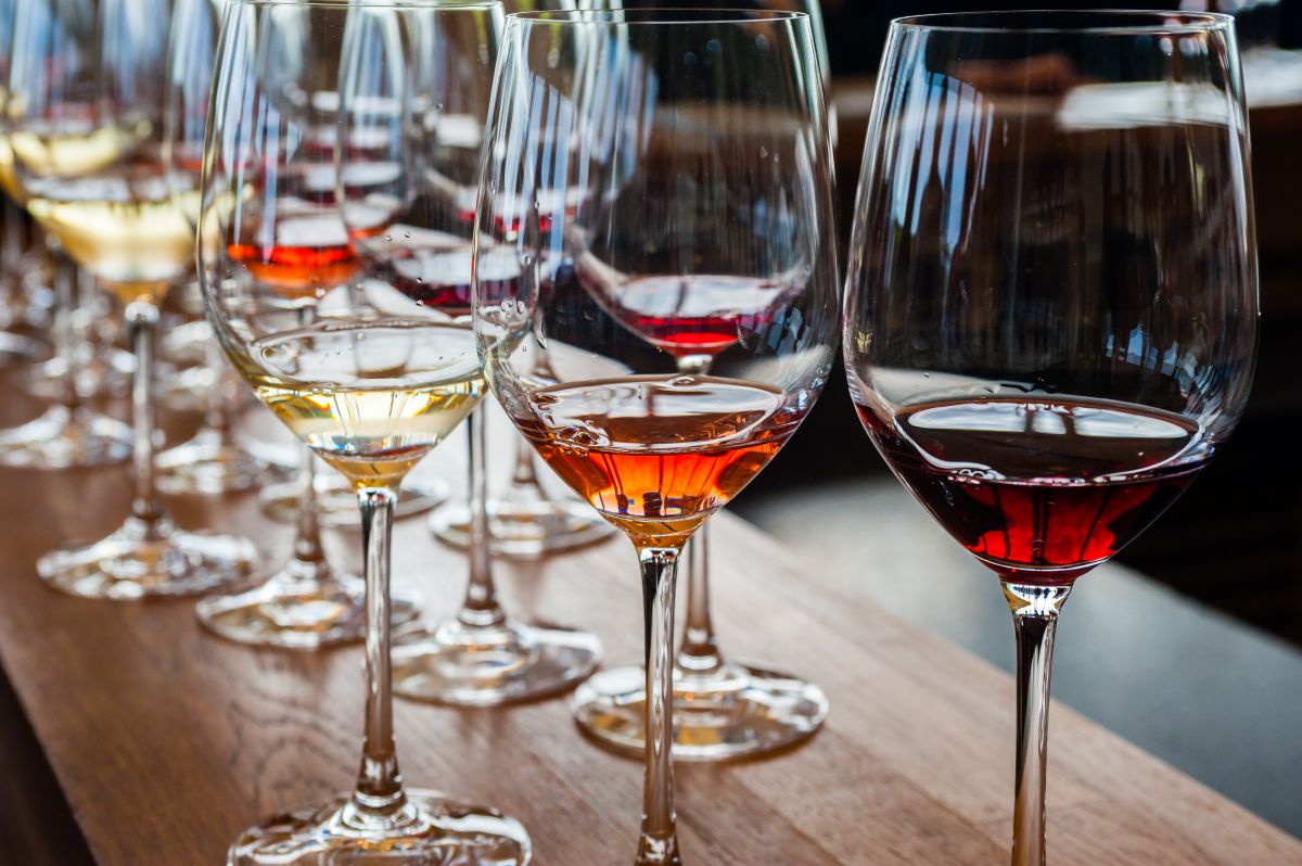 Close-up of wine glasses being poured during an elegant tasting event