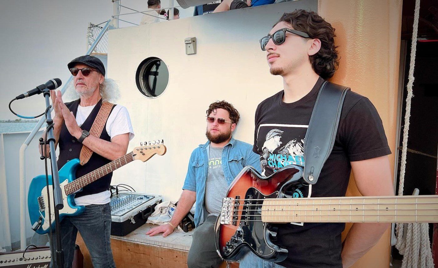 Band with two guitars performing a boat