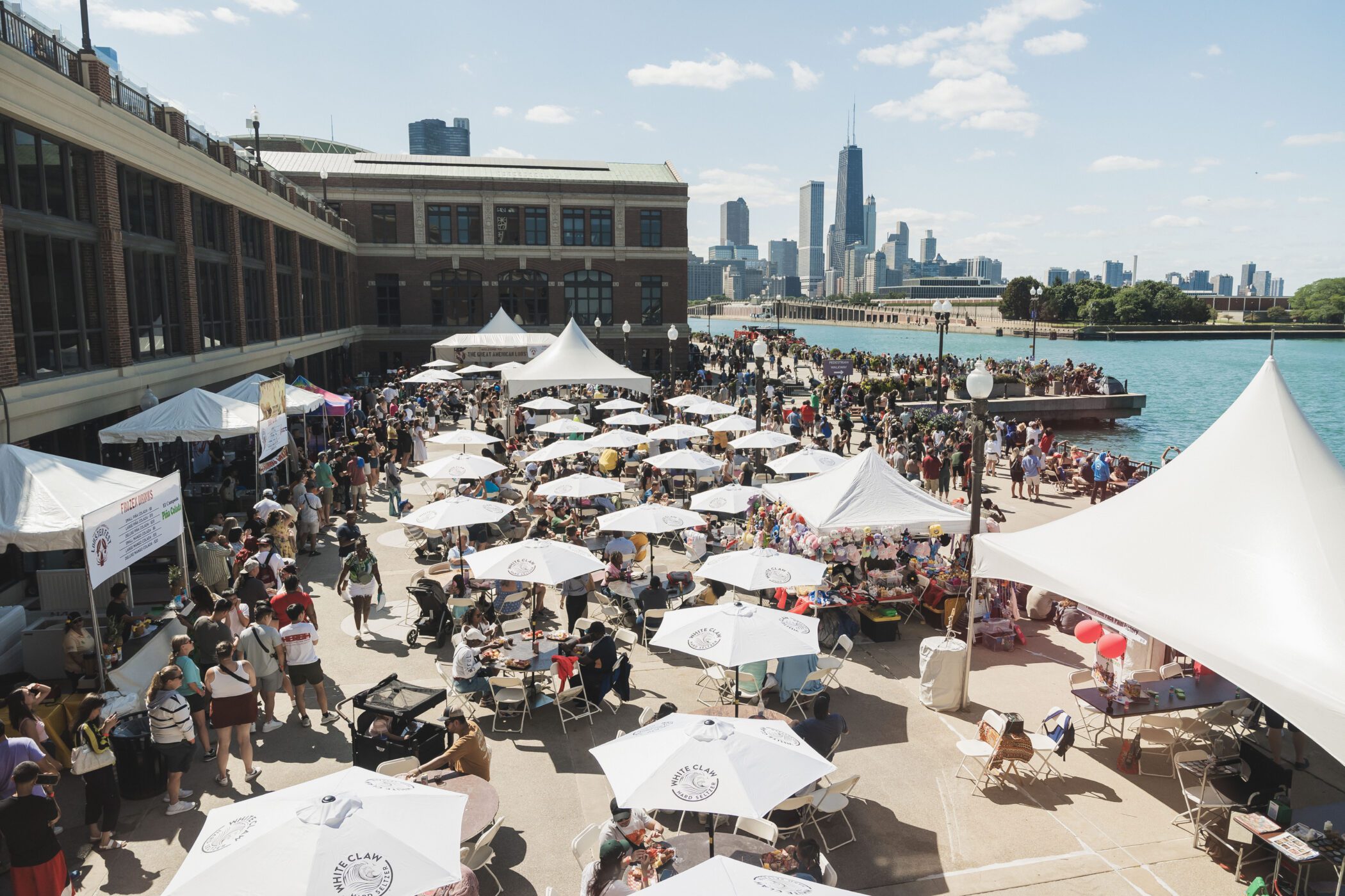 People standing at food vendor tables during Lobster Fest