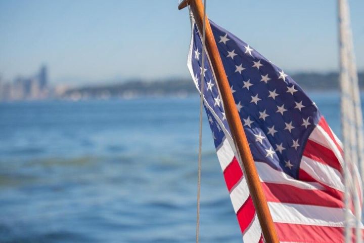 American flag flying with the lake in the background