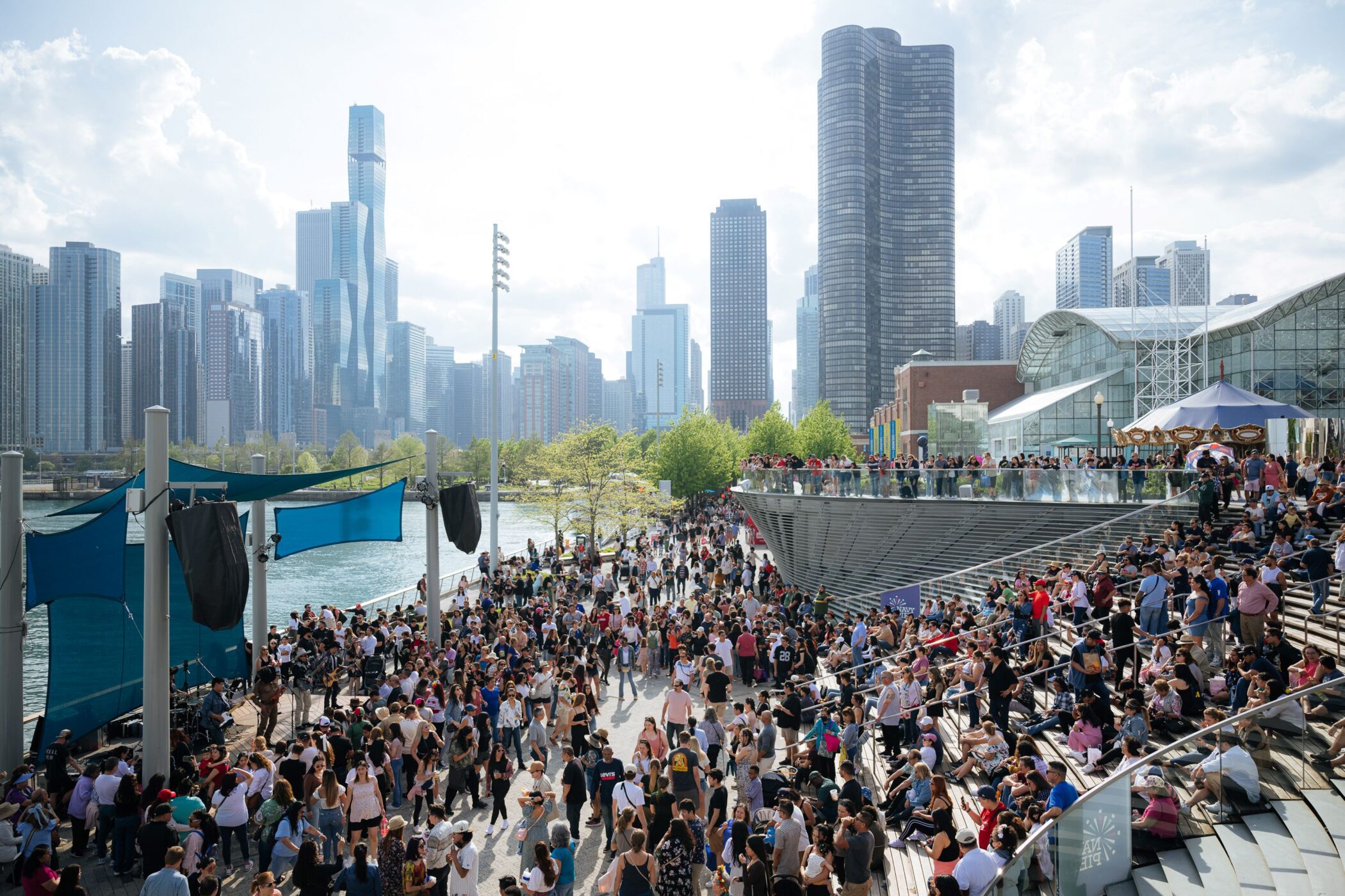 Crowd enjoying events at Navy Pier with Chicago skyline in background