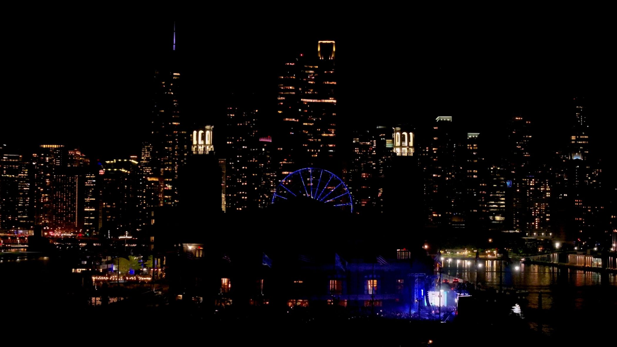 Chicago skyline at night with Navy Pier's illuminated Ferris wheel