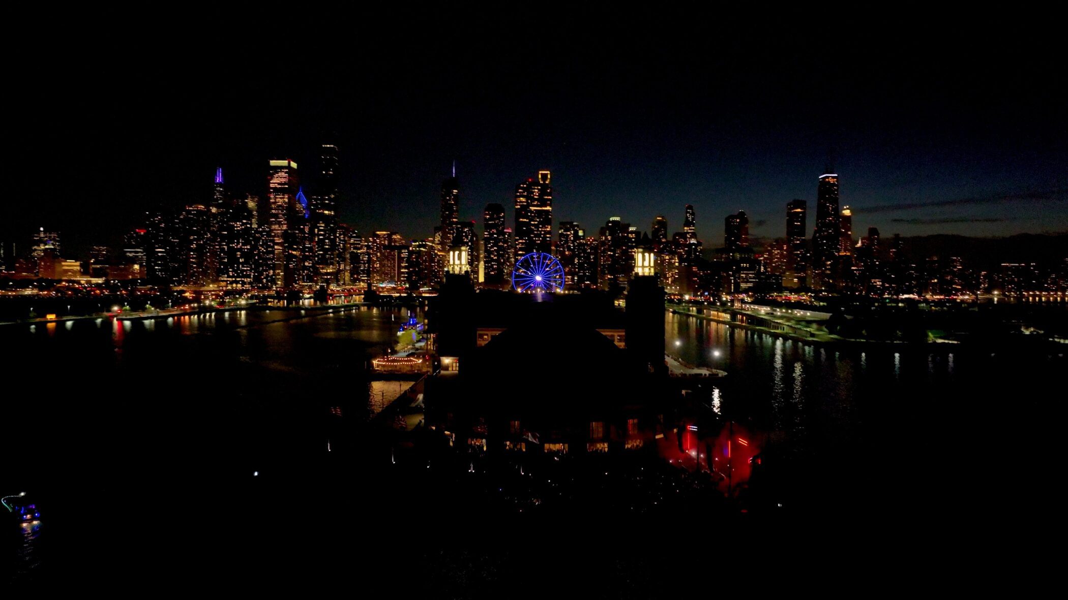 Chicago skyline at night with Navy Pier's Ferris wheel illuminated