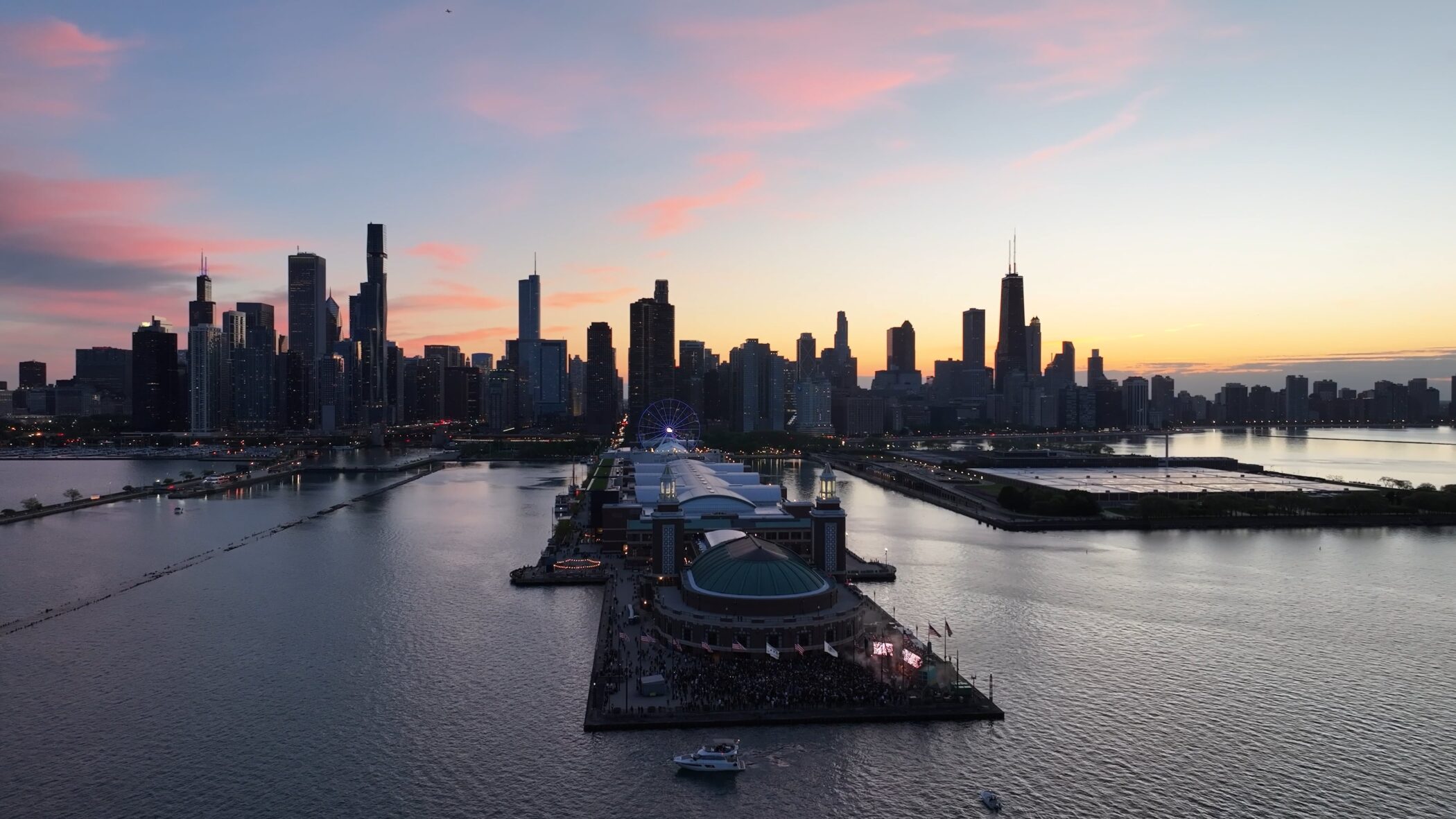 Aerial view of Navy Pier at sunset with Chicago skyline, showcasing East End Plaza events.