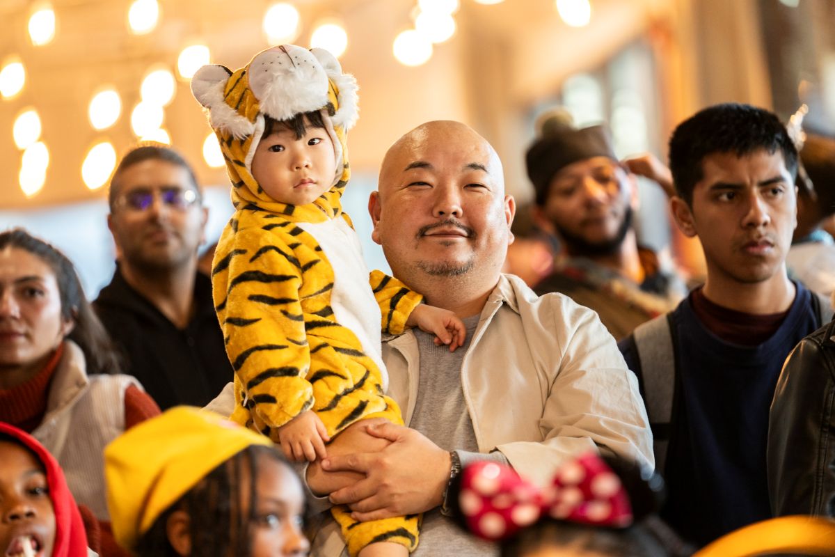 Families enjoy Slightly Spooky Saturday at Navy Pier, featuring a child in a tiger costume.