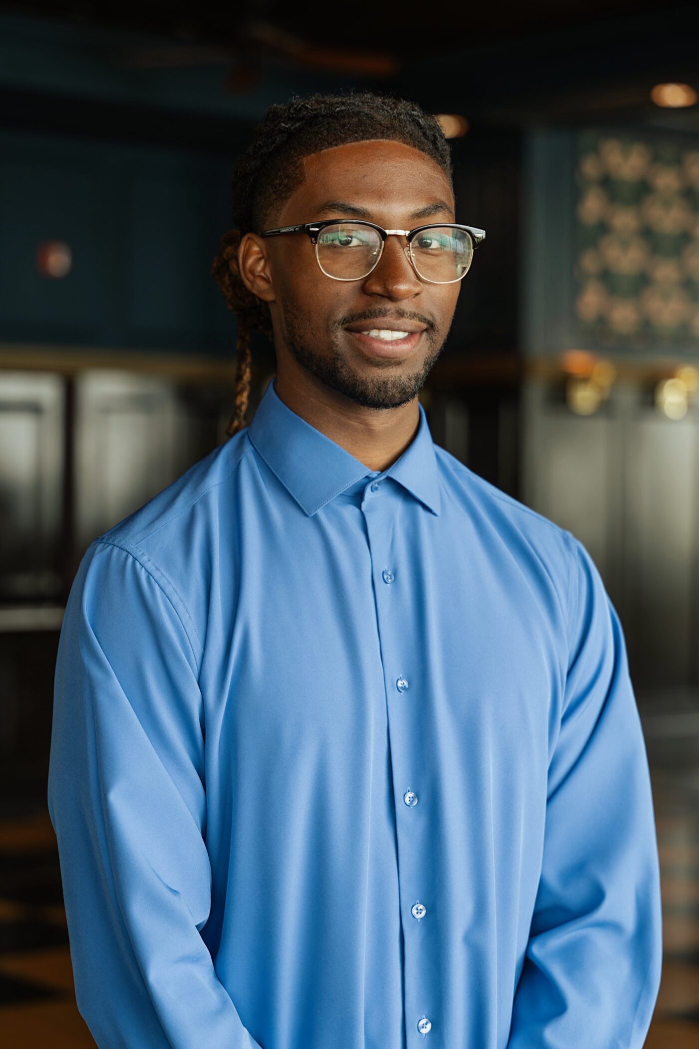 Smiling man in a blue shirt at the Small Business Accelerator Program