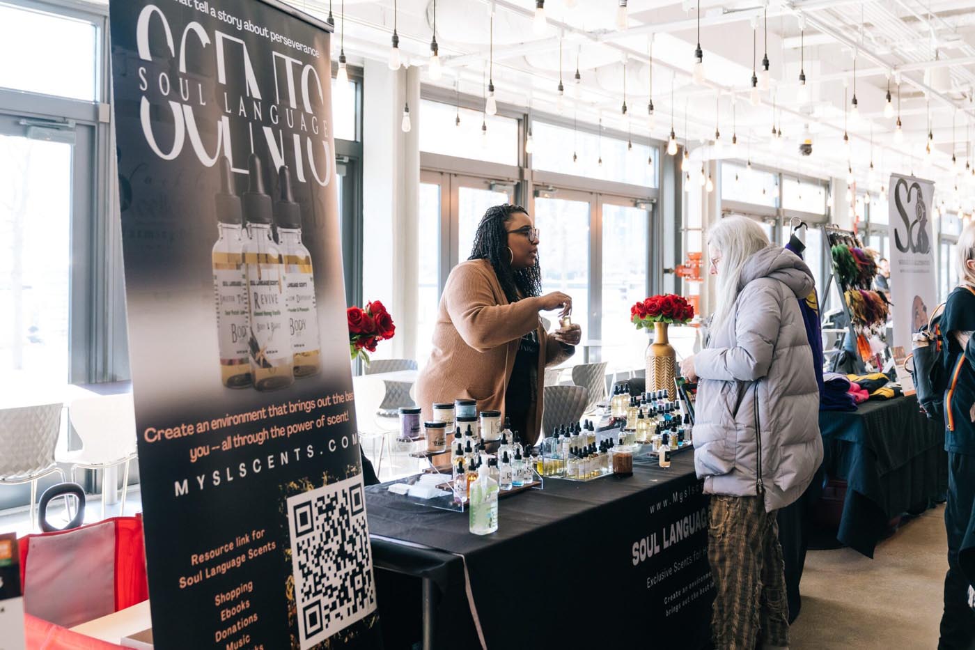 Person discuss' product at an Artisan Market stand