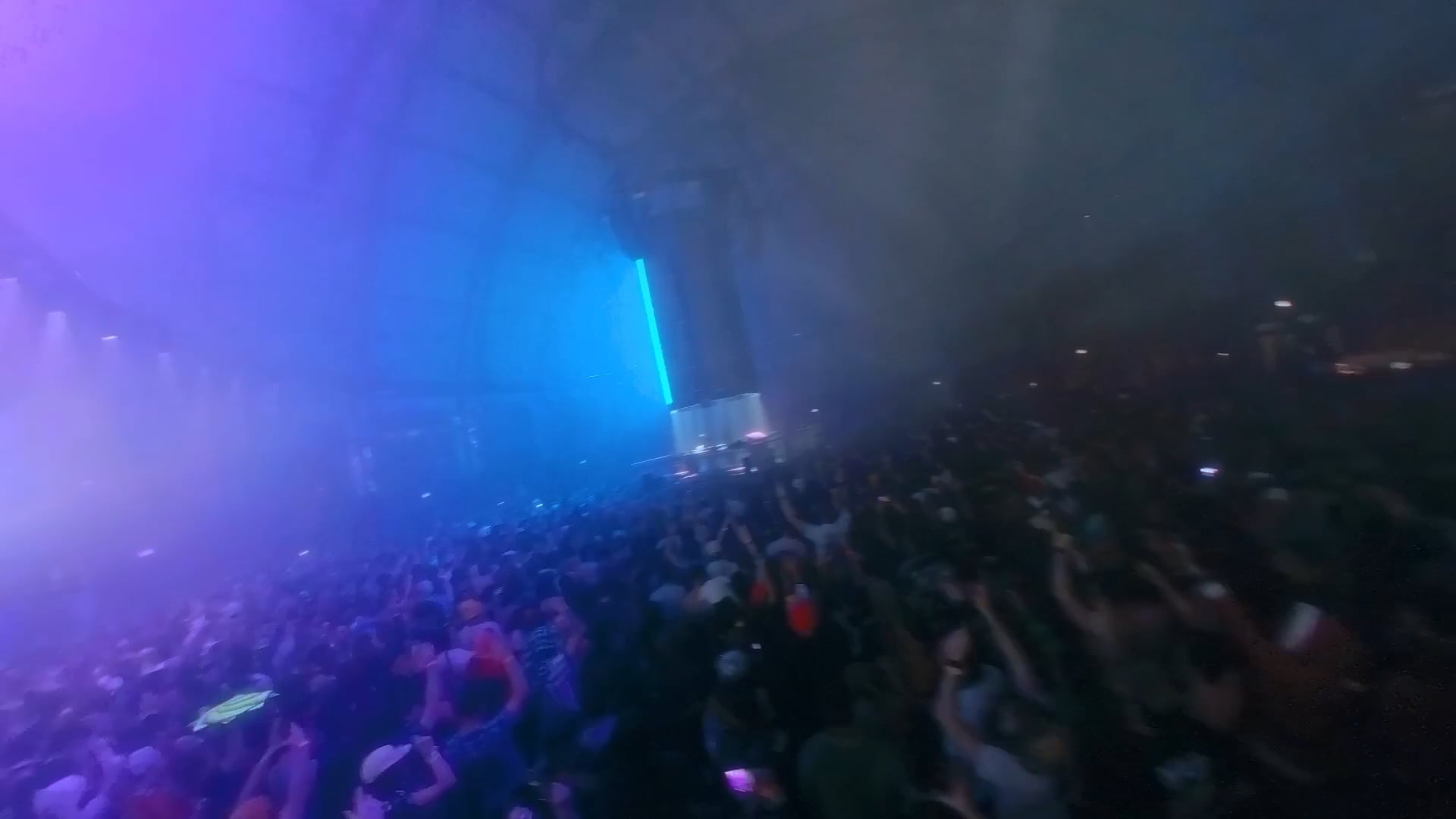 Concert crowd bathed in blue lighting at an indoor venue at Navy Pier