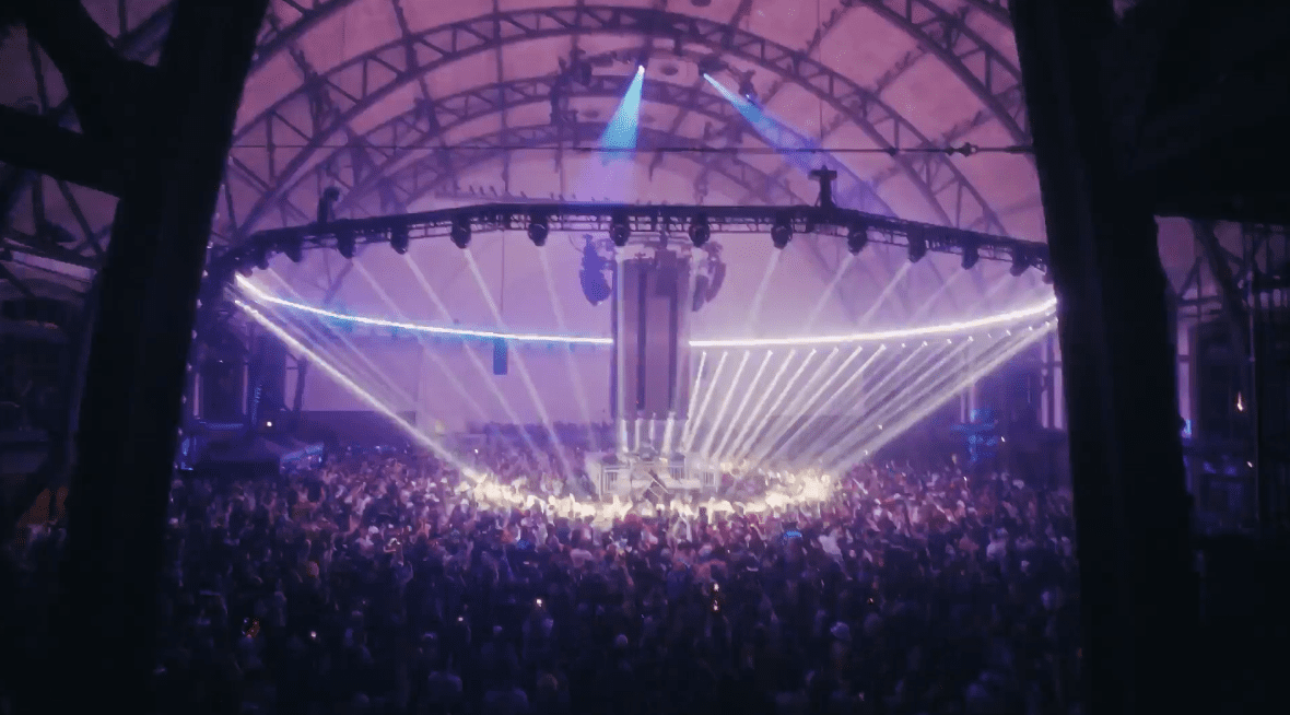Vibrant colored lights illuminating an indoor concert at Navy Pier
