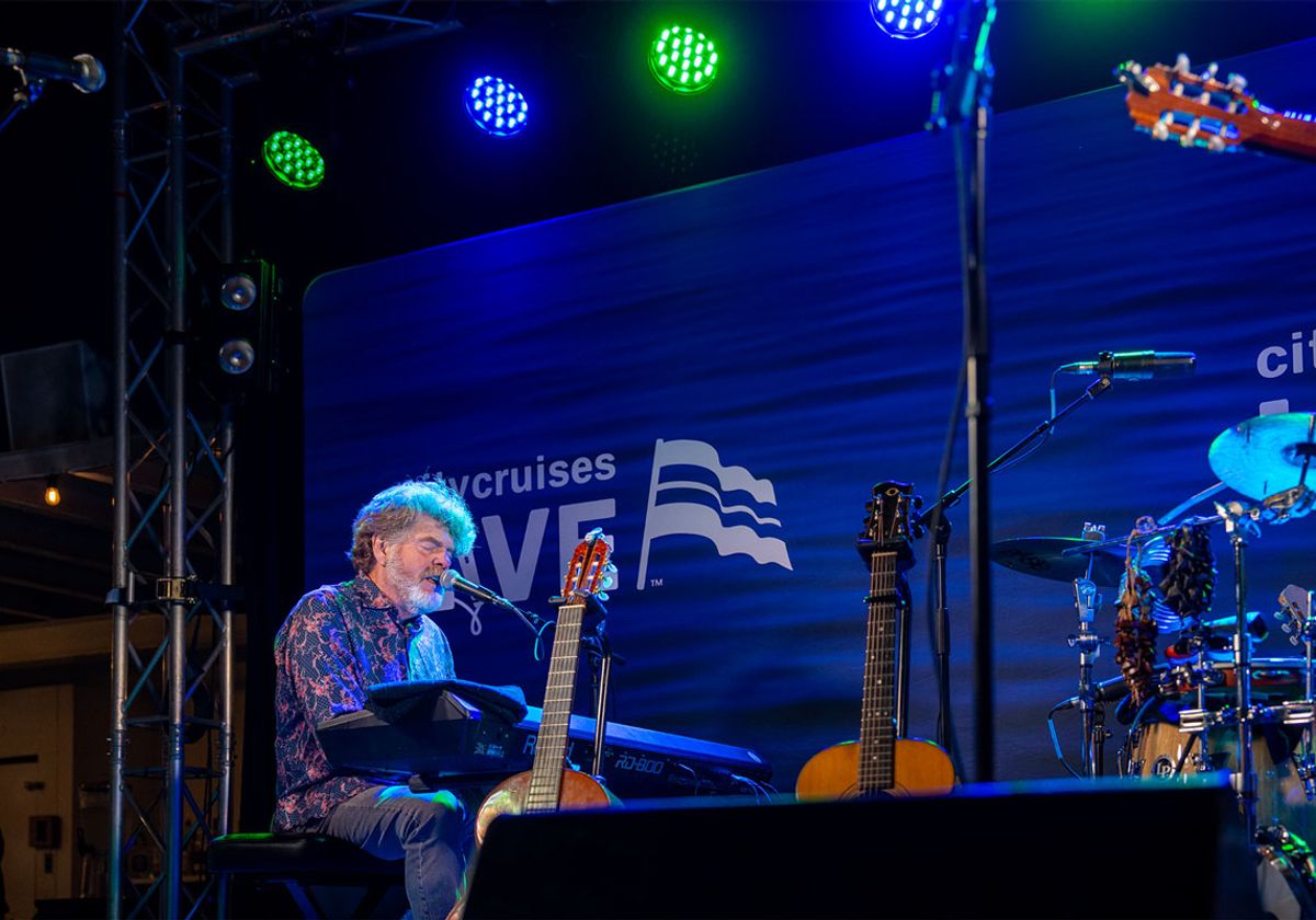 Musician performing on keyboard on stage during a City Cruises event at Navy Pier
