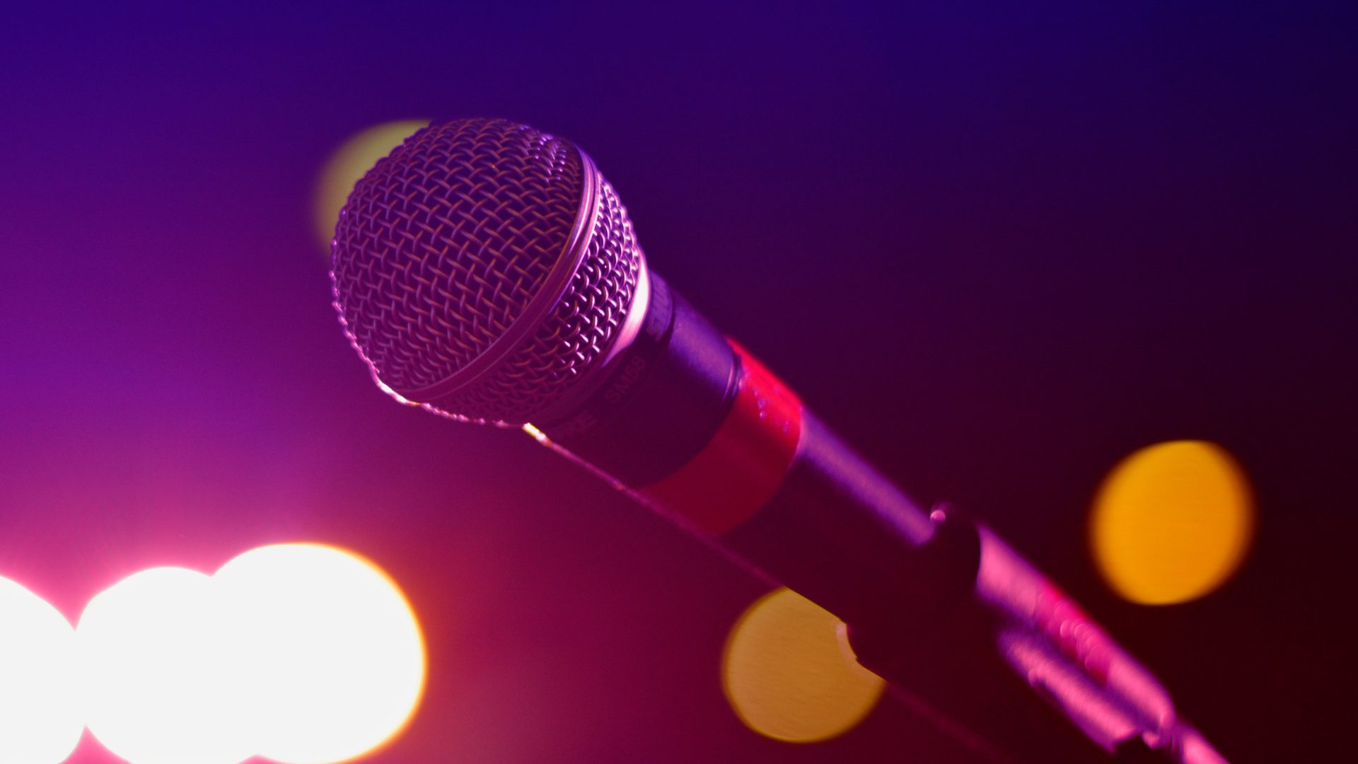 Microphone stand on a stage with colorful lights at Navy Pier