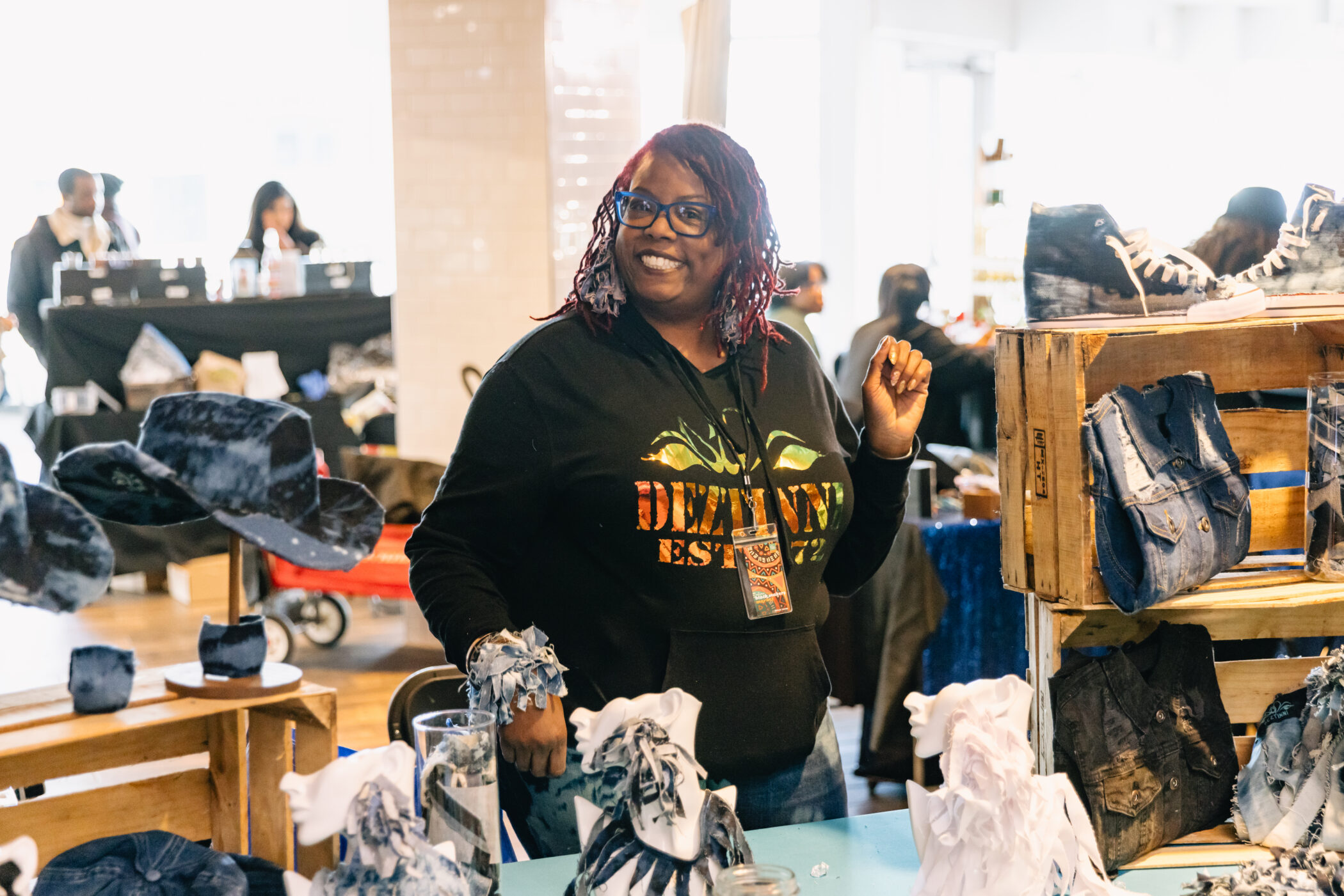 Vendor booth displaying denim bags and accessories at Navy Pier market