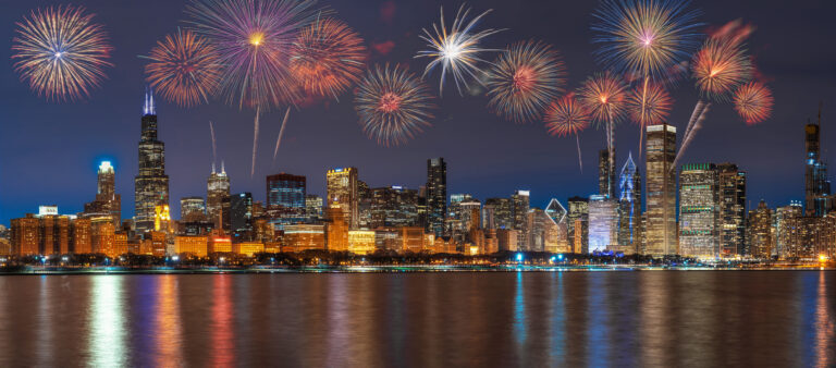 Fireworks bursting over the Chicago skyline and lakefront at night