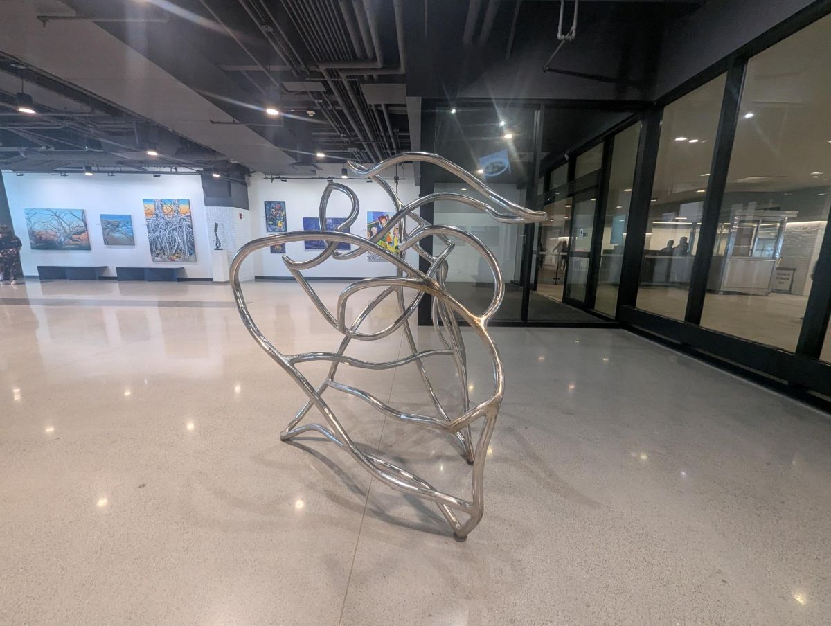 Looping steel sculpture in a gallery corridor at Navy Pier